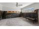 Room with concrete floor, exposed walls, ceiling fan, and bench at 106 13Th Ave, St Pete Beach, FL 33706