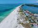 Expansive aerial shot of a coastal community featuring sandy beaches and vibrant ocean views at 1070 Eldorado Ave, Clearwater Beach, FL 33767