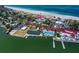 Aerial view of coastal community with tennis court, pool, and private beach at 1070 Eldorado Ave, Clearwater Beach, FL 33767