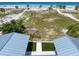 Aerial view of the yard with an outdoor entertaining area and nearby beach at 1070 Eldorado Ave, Clearwater Beach, FL 33767