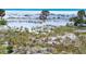 Beautiful sandy beach featuring lush dunes with tropical plant life and crystal water at 1070 Eldorado Ave, Clearwater Beach, FL 33767