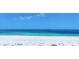 Calm beach scene with blue skies meeting the tranquil turquoise ocean waters on a sunny day at 1070 Eldorado Ave, Clearwater Beach, FL 33767