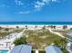 Sweeping beach view, complete with white sand and swaying palms against a blue sky at 1070 Eldorado Ave, Clearwater Beach, FL 33767