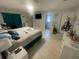 Spacious bedroom with tile floors, a ceiling fan, and ensuite bathroom at 11010 Salt Tree Dr, Port Richey, FL 34668