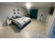Spacious bedroom with tile floors, a ceiling fan, and a large bed at 11010 Salt Tree Dr, Port Richey, FL 34668