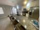 Modern kitchen featuring granite countertops, stainless steel appliances, and pendant lighting at 11010 Salt Tree Dr, Port Richey, FL 34668
