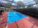 A private screened-in pool with a metal and screen cage for comfortable outdoor living at 11010 Salt Tree Dr, Port Richey, FL 34668