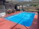 A private screened-in pool and outdoor kitchen create a relaxing backyard oasis for comfortable outdoor living at 11010 Salt Tree Dr, Port Richey, FL 34668