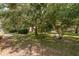 Spacious backyard surrounded by mature trees and manicured lawn at 1142 Sweet Jasmine Dr, Trinity, FL 34655