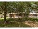 Green backyard with mature trees providing shade and privacy at 1142 Sweet Jasmine Dr, Trinity, FL 34655