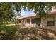 View of home's backyard featuring mature trees and a well maintained lawn at 1142 Sweet Jasmine Dr, Trinity, FL 34655