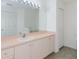 Bathroom featuring a large mirror, pink countertops, white cabinets, and tile flooring at 1142 Sweet Jasmine Dr, Trinity, FL 34655