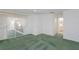 Spacious bedroom with green carpet, white walls, walk-in closet, and attached bath at 1142 Sweet Jasmine Dr, Trinity, FL 34655