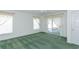 Bedroom with green carpet, white walls, and sliding door to outdoor seating at 1142 Sweet Jasmine Dr, Trinity, FL 34655