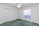 Bedroom featuring green carpets, a ceiling fan, a large window, and a closet at 1142 Sweet Jasmine Dr, Trinity, FL 34655