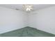 Bedroom features green carpets, a ceiling fan, and two large closets at 1142 Sweet Jasmine Dr, Trinity, FL 34655