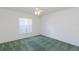 Bedroom featuring green carpets, a ceiling fan, and a large window at 1142 Sweet Jasmine Dr, Trinity, FL 34655
