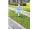 Community sign that says 'Caution Adults at Play' adding a whimsical touch at 1142 Sweet Jasmine Dr, Trinity, FL 34655