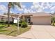 Charming single-story home featuring a well-manicured lawn and a two-car garage, with brick accents at 1142 Sweet Jasmine Dr, Trinity, FL 34655