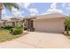 Charming single-story home featuring a well-manicured lawn, brick accents and a two-car garage at 1142 Sweet Jasmine Dr, Trinity, FL 34655