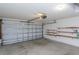 Spacious two-car garage featuring multiple shelves and an automatic garage door opener at 1142 Sweet Jasmine Dr, Trinity, FL 34655