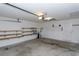 Bright garage featuring pegboard and shelves for storage and a water heater at 1142 Sweet Jasmine Dr, Trinity, FL 34655