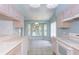 Kitchen featuring stylish cabinets and a view of a bright breakfast nook at 1142 Sweet Jasmine Dr, Trinity, FL 34655