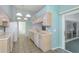 Kitchen with appliances, tile floor, and sliding glass door to screened area at 1142 Sweet Jasmine Dr, Trinity, FL 34655