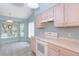 Kitchen featuring ample cabinetry, tile floors, and a large window with a view at 1142 Sweet Jasmine Dr, Trinity, FL 34655