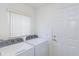 Well-lit laundry room featuring side-by-side washer and dryer at 1142 Sweet Jasmine Dr, Trinity, FL 34655