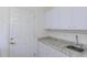 Laundry area with white cabinets, granite countertop, and utility sink at 1142 Sweet Jasmine Dr, Trinity, FL 34655