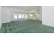 Open living room with sliding glass doors and view into kitchen at 1142 Sweet Jasmine Dr, Trinity, FL 34655