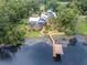 Stunning aerial view of the lakeside property featuring a private dock at 13533 Bay Lake Ln, Tampa, FL 33618