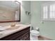 Bathroom featuring a granite countertop, modern fixtures, and bright lighting at 13533 Bay Lake Ln, Tampa, FL 33618