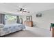 Bedroom featuring a ceiling fan, natural light, and carpet floors at 13533 Bay Lake Ln, Tampa, FL 33618