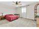 Cozy bedroom with a ceiling fan, and a window with wooden blinds at 13533 Bay Lake Ln, Tampa, FL 33618