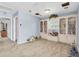 Bright bonus room featuring a built-in bookcase and neutral carpet at 13533 Bay Lake Ln, Tampa, FL 33618