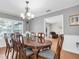 Formal dining room with chandelier and ample seating at 13533 Bay Lake Ln, Tampa, FL 33618