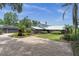 Well maintained single-story home featuring a brick paver walkway, lush landscaping, and multiple garages at 13533 Bay Lake Ln, Tampa, FL 33618