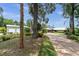 Long driveway leading to a beautiful brick home with mature trees and lush landscaping at 13533 Bay Lake Ln, Tampa, FL 33618