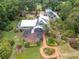 Gorgeous exterior view showcasing screened in pool area, lush landscaping, and connecting wooden walkway at 13533 Bay Lake Ln, Tampa, FL 33618