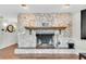 Close up of the impressive stone fireplace with brick hearth and decorative mantle at 13533 Bay Lake Ln, Tampa, FL 33618