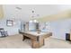Spacious game room featuring a pool table, pendant lighting, and light blue walls at 13533 Bay Lake Ln, Tampa, FL 33618
