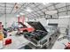Spacious garage with high ceilings and multiple classic cars being repaired at 13533 Bay Lake Ln, Tampa, FL 33618