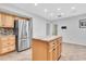 Spacious kitchen with stainless refrigerator, center island, and stylish wood cabinetry at 13533 Bay Lake Ln, Tampa, FL 33618