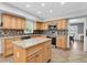 Well-lit kitchen features granite countertops, stainless appliances and a center island at 13533 Bay Lake Ln, Tampa, FL 33618