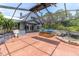 The enclosed patio features a hot tub and tranquil pond, perfect for relaxation or entertaining at 13533 Bay Lake Ln, Tampa, FL 33618