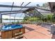 Enclosed patio features a hot tub and views of the lake, perfect for relaxing outdoors at 13533 Bay Lake Ln, Tampa, FL 33618