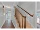 Carpeted staircase with wood banister and railing leading to upper floors of the home at 13533 Bay Lake Ln, Tampa, FL 33618