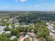 Scenic aerial view of the home in a neighborhood with mature trees, nearby buildings, and views of the ocean at 1400 23Rd S Ave, St Petersburg, FL 33705